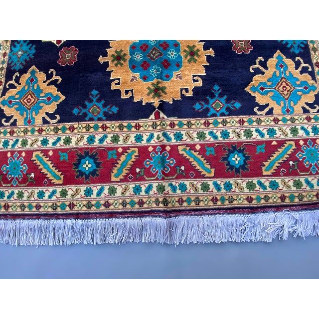 Handmade Afghan Bokhara Medallion Rug – Rich Red, Blue & Gold Tribal Design – 4'8" X 6'9" For Sale - Image 4 of 10