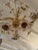 Elegant glistening flower motif vintage chandelier having delicate 24 carat plated stems and floral centers with crystal...