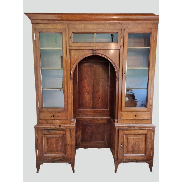 An important Venetian bookcase from the early 19th century, crafted entirely from solid walnut. The solid and well-...