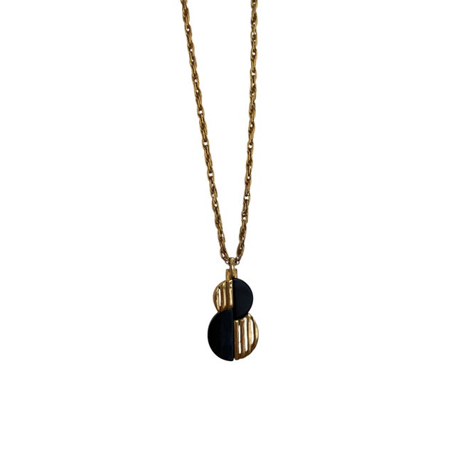 This is a vintage modernist gold-tone chain necklace by Crown Trifari featuring a geometric black bakelite pendant. Brand:...