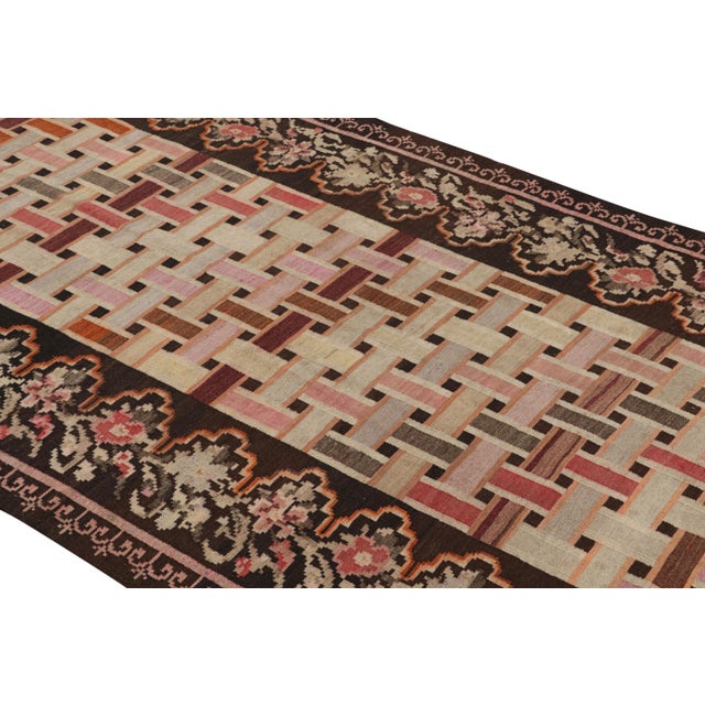 Hand woven in a wool flat weave originating from Turkey circa 1950-1960, this vintage Kilim rug connotes a mid-century...