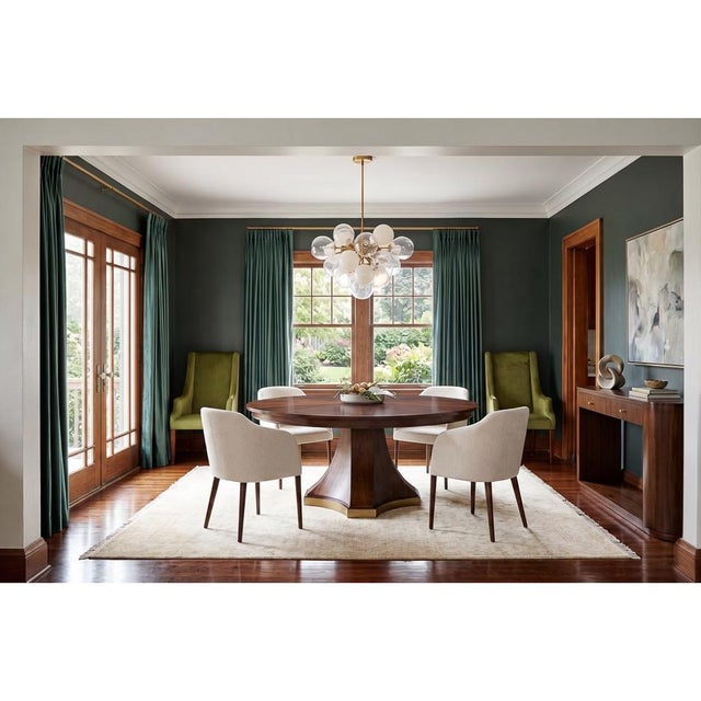 This Dining Table showcases a striking sunburst walnut veneer that radiates elegantly from the center, creating a sense of...