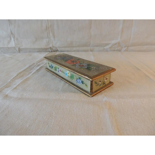 Reversed painted glass on wood frame and gold leaf details. Size: 8" L x 3" D x 2" H.