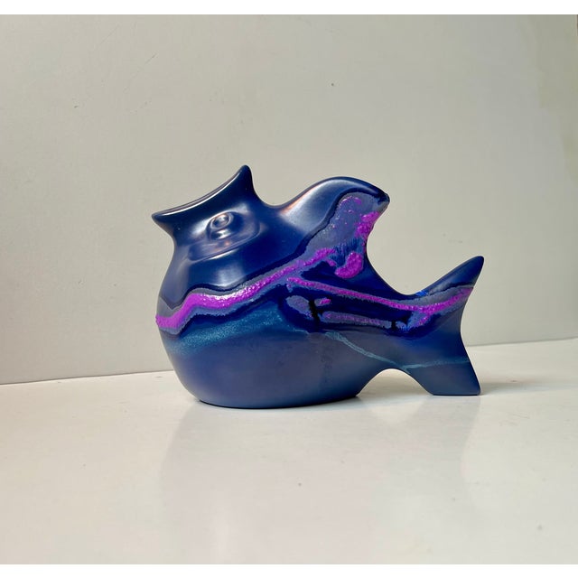 Sculptural money bank i the shape of a fish. Blue/purple main glazes with hand-applied magenta, ble and light-blue...
