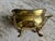 A diminutive hammered brass oval cachepot or jardiniere with solid brass carrying handles and solid brass paw feet, the...