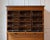 An early 20th-century Italian wooden filing cabinet, dating to the early 1900s, combining functional design with...