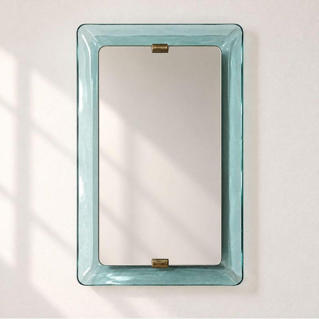 An elegant Italian wall mirror from the 1950s, designed by Max Ingrand for Fontana Arte and featuring a refined structure...