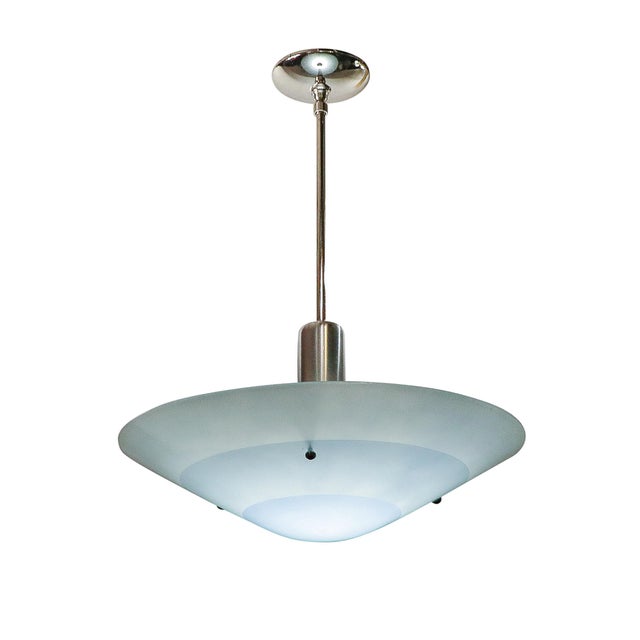 This streamlined and dynamic Art Deco Sky Blue Glass Pendant Chandelier originates from the United States, Circa 1940....