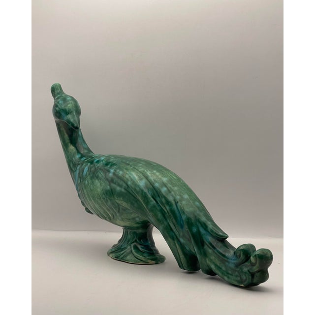 A vintage stylized peacock statue in the art deco style.