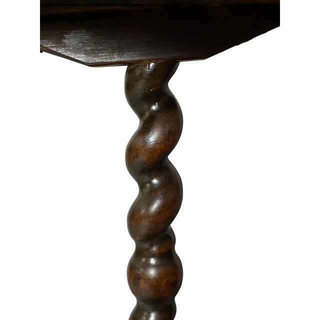 Octagonal top and barley twist support ending on an X-form platform base.