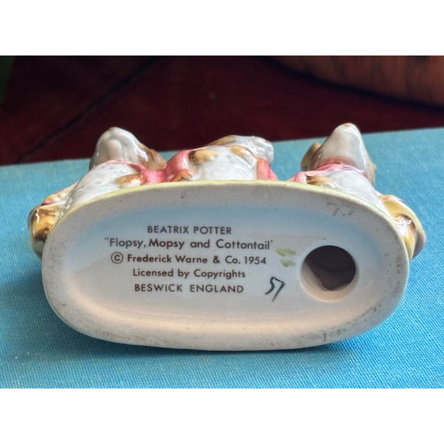 Delightful figures of Flopsy, Mopsy, and Cottontail from the stories written by Beatrix Potter and published by Frederick...