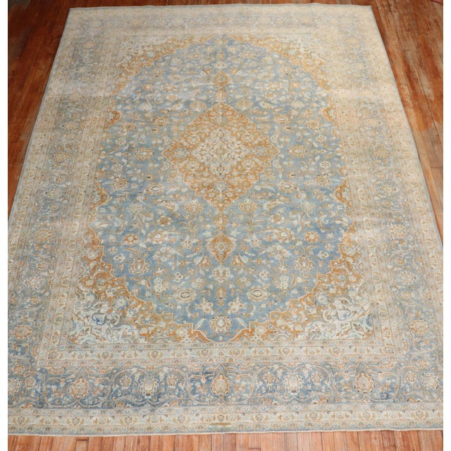 An early 20th Century room size Persian Kashan hand-knotted rug with a traditional medallion and border pattern in blue...