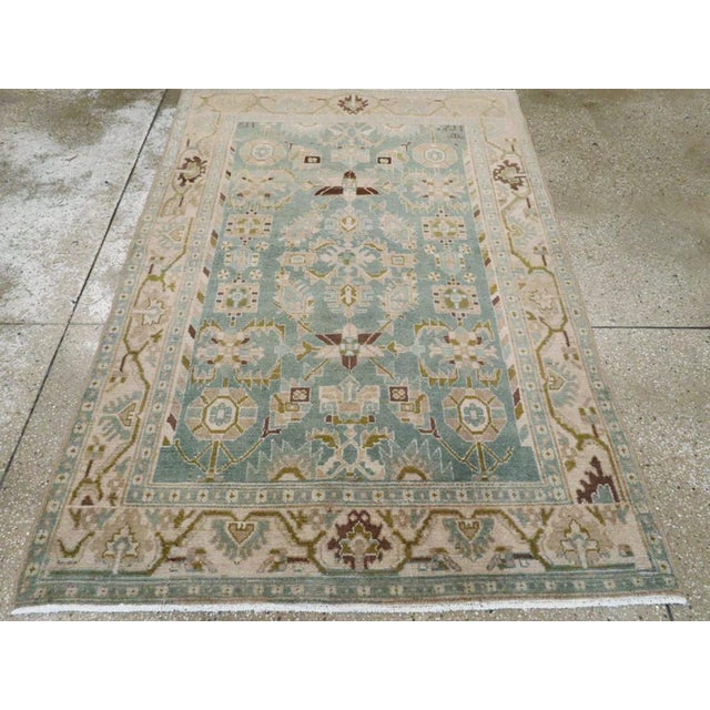 This mid-20th-century Persian Malayer accent rug presents a refined floral and geometric composition across a soft blue...