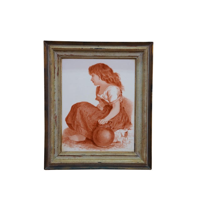 Two antique porcelain framed tiles depicting a young peasant girl resting bare-footed next to a water jug and a young girl...