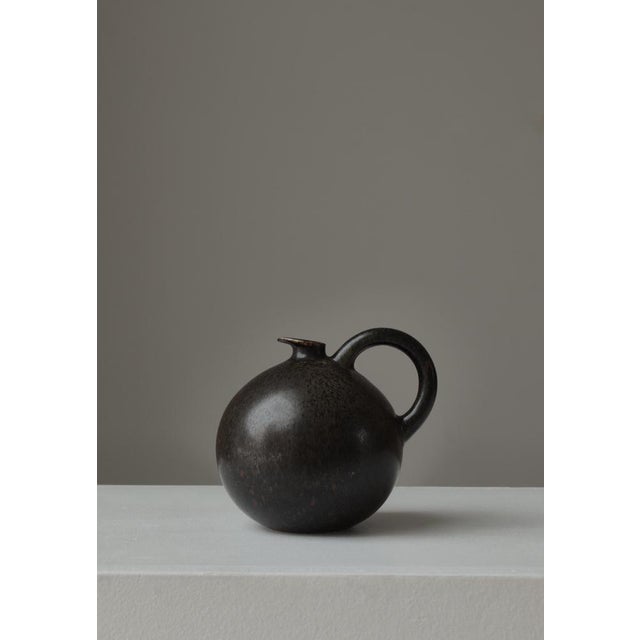 Beautiful spherical stoneware jug with handle and small spout made at Saxbo in Herlev, Denmark (1930/40s). Made from hand-...