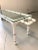 A mid-century, hand-painted coffee table with faux bamboo motif detailing with glass top and handles on opposing ends....