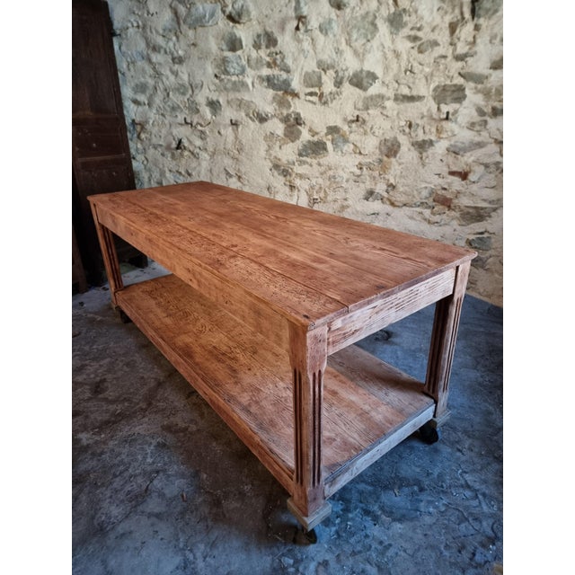 An antique French work table originating from an atelier and dating from the early 20th century. Constructed from solid...