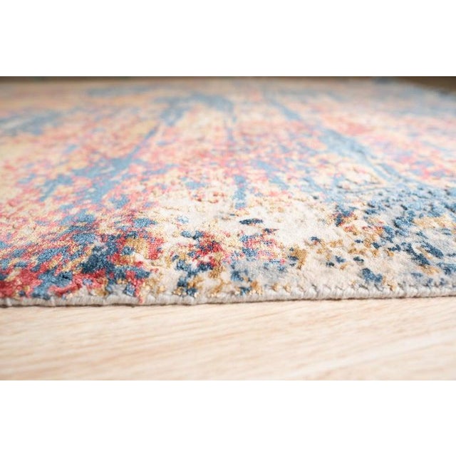 This hand knotted pile rug features a blend of wool and viscose materials, designed to provide a durable floor covering....