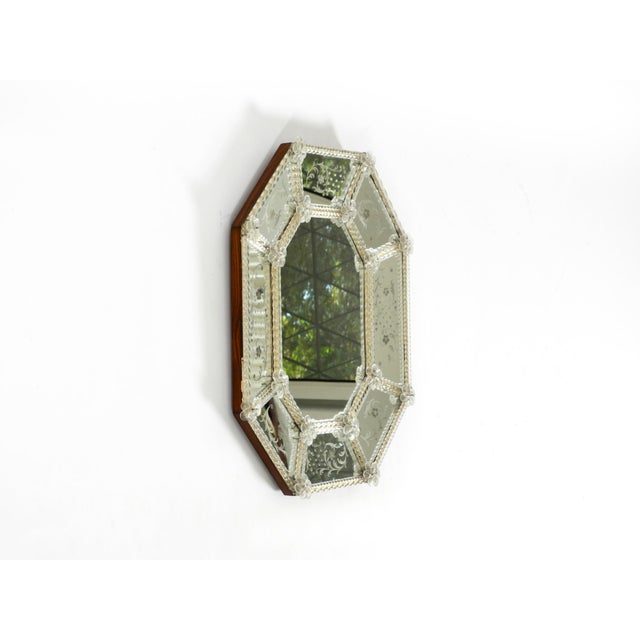 An exceptionally rare and stunningly beautiful Italian mid-century octagonal wall mirror featuring an elaborate Murano...