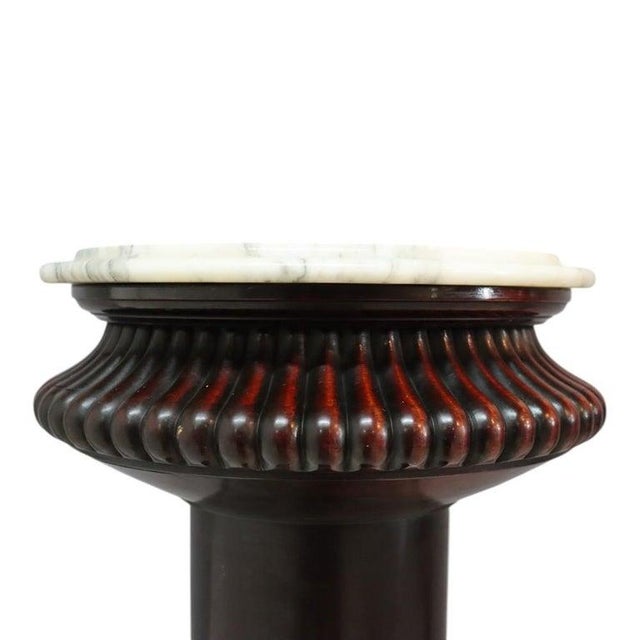 An antique Victorian Classical sculpture stand, crafted from rich mahogany wood with a polished white marble top. This...