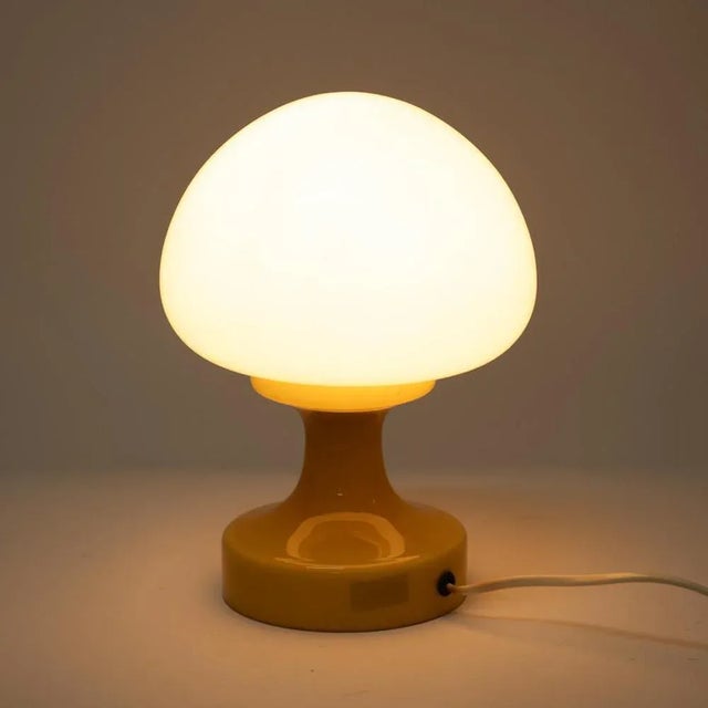 A blown glass table lamp in the Brussels style. Designed in the 1970s, it is an example of the Space Age style, which...