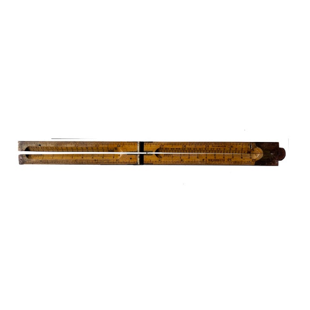Cleverly designed antique four-part collapsible boxwood and brass ruler. In addition to showing inches, it has 4 bevelled...