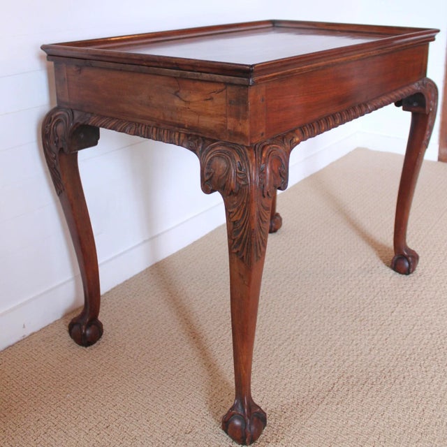 Attributed to New York, ca. 1760-1780, this handsome and boldly carved table features a typical design element of New York...
