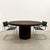 A rare and sophisticated round dining table re-veneered in rich chocolate brown cork, professionally finished with a...