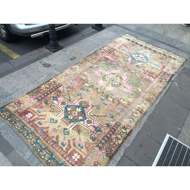 This is a vintage Turkish Oushak rug from the 1960s. The piece was hand-knotted.