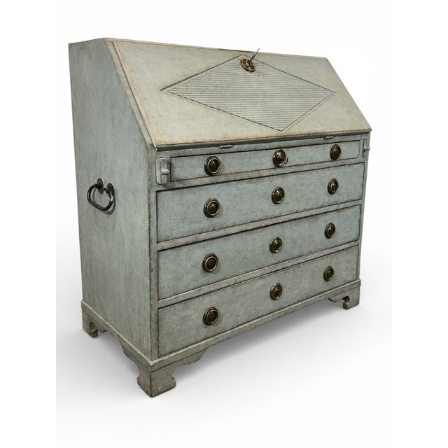 Antique Swedish secretary in light blue. The desk's lid is decorated with a rhombus-shaped pattern. When opened, the lid...