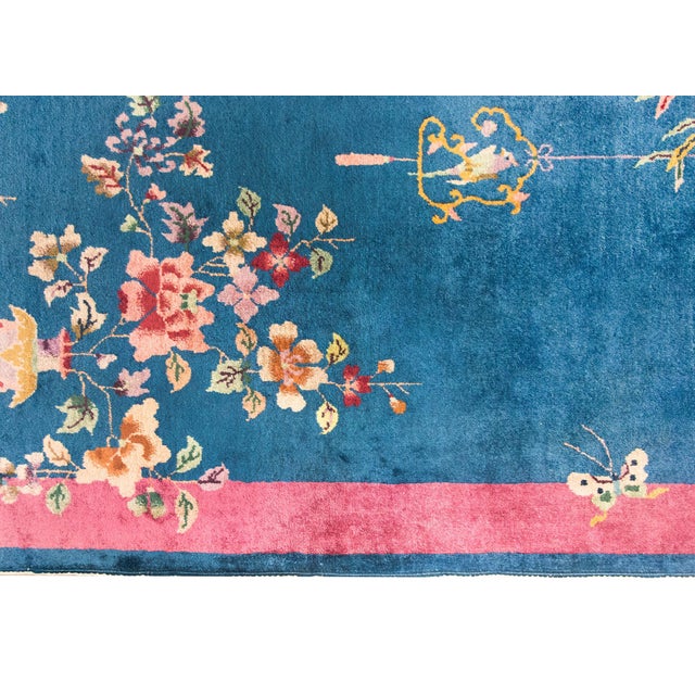 A stunning example of early 20th-century Chinese Art Deco weaving, this rug features a deep navy blue field framed by a...