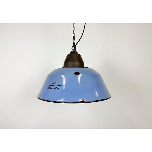 Industrial hanging lamp manufactured by Szarvasi Vas - Fém in Hungary during the 1960s. It features a blue enamel shade,...