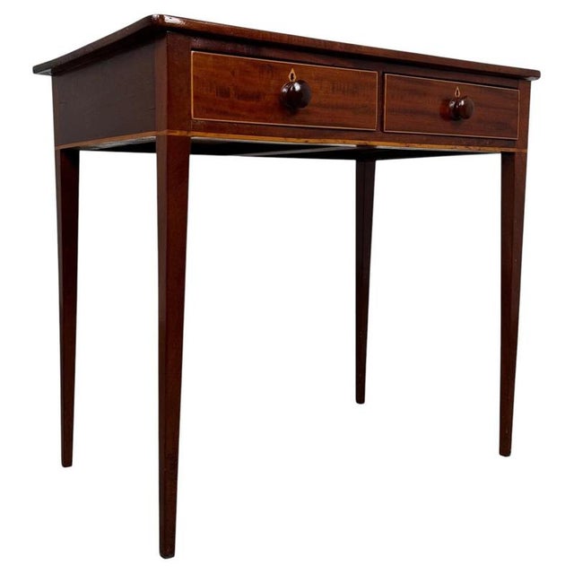 A refined 18th-century English writing table, finely crafted from mahogany and distinguished by elegant proportions,...
