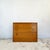 Teak-veneered carcase construction on a plinth base with rounded front corners. Three full-width graduated drawers....