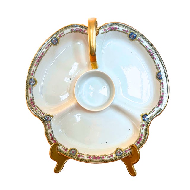This vintage Limoges porcelain divided dish, circa 1960, exudes timeless elegance with its refined craftsmanship....