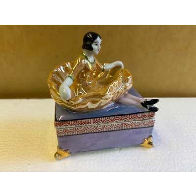 Covered Ceramic Box with a girl holding her dress up to act as a holding spot for rings etc. Produced by Seiei & co. Made...