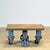 A 1960s industrial coffee table featuring a combination of a heavy wooden top and a robust metal base. The weathered wood...