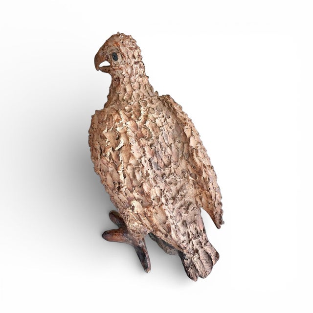A substantial, handbuilt studio pottery bird perched on a rock or branch. Heavy earthenware and glaze, low-fired....