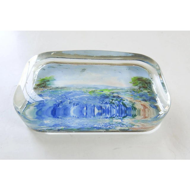 Vintage glass paperweight with reverse painted bluebonnet landscape painting. Unsigned, few scuff marks on glass.