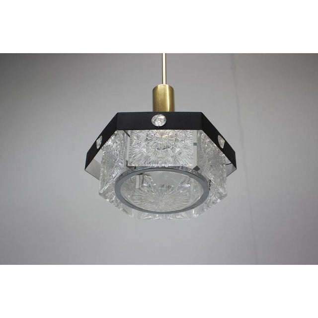 Elegant pendant light produced in Kamenický Šenov, Czechoslovakia during the 1970s. This sophisticated Mid-Century Modern...