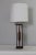 Sculptural table lamp. Beautiful hand rubbed walnut mounted on cast enameled alabaster colored base and stem. Helps to...