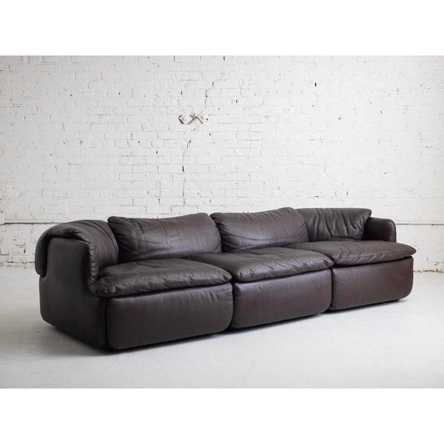 Brown leather three-seater sofa by Alberto Rosselli for Saporiti's Confidential collection. Matching armchair available,...