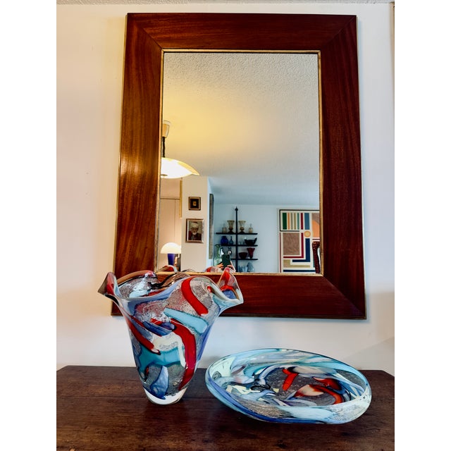 A very unique and large walnut wall mirror; of highly sculptural form with elegant lines and sophisticated styling and...