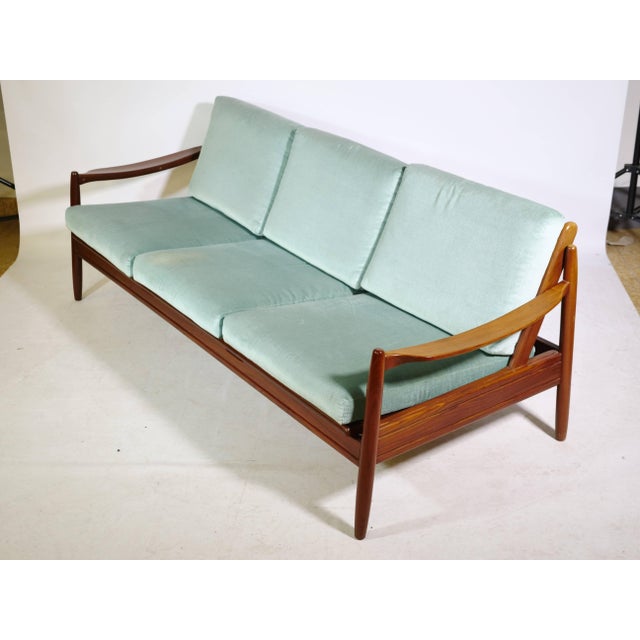 Danish Design teak sofa from the 1960s. Three-seater with a pull-out seat and removable cushions. Can be used as a daybed...