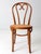 This is a mid 20th century vintage bentwood chair. Made in Romania, the classic Thonet style cafe chair has a caned seat.