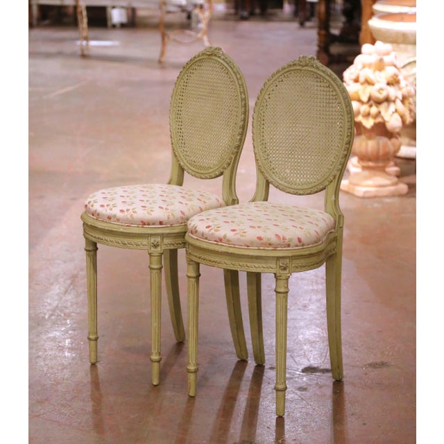 This elegant pair of antique French Louis XVI side chairs was crafted in France circa 1920 from carved beech wood. Each...