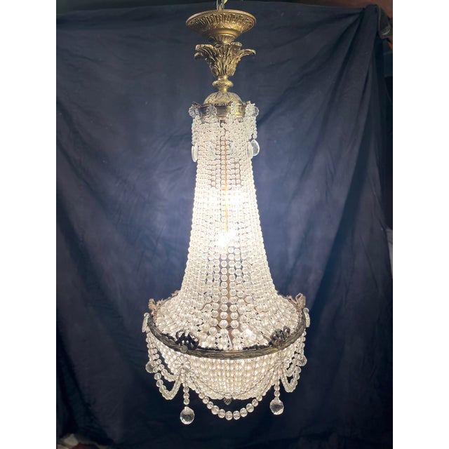 This seven light crystal French empire chandelier has the most beautiful proportions and shines with every original piece...