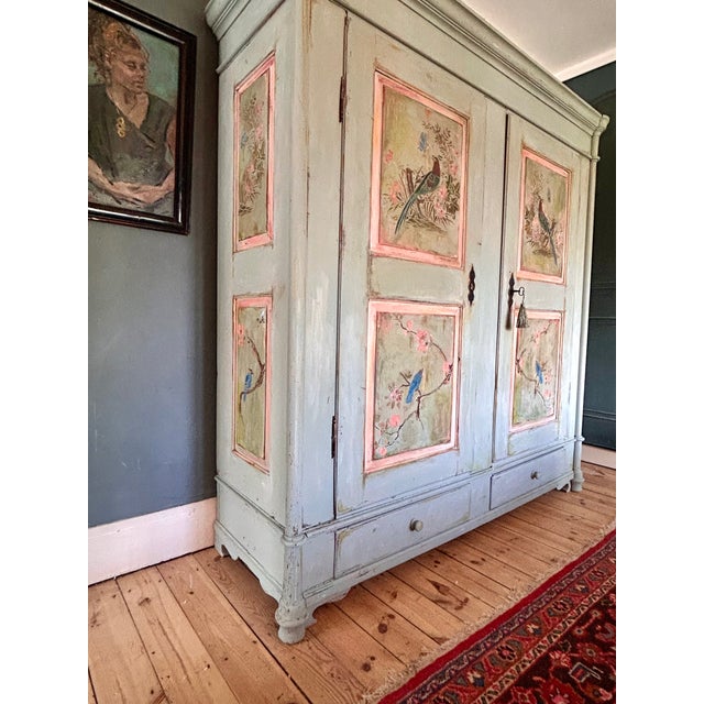 Stunning large double wardrobe we have added inlaid chinoiserie panels . The armoire has a gorgeous aged patina. it has...