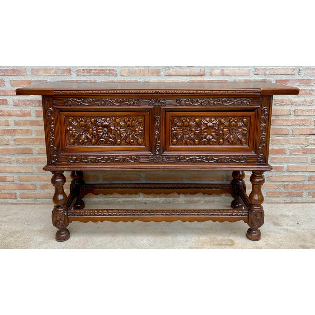 Impressive Spanish sideboard dating from the mid-20th century, crafted in wood and richly decorated with elaborate carved...