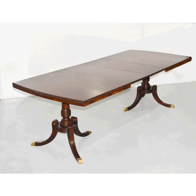 This handsome vintage dining table features a classic silhouette and is crafted from solid wood. The table sits on two...